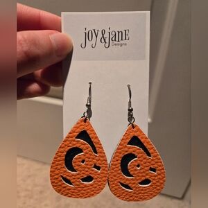 Orange and Black Teardrop Earrings with Intricate Cutout Design